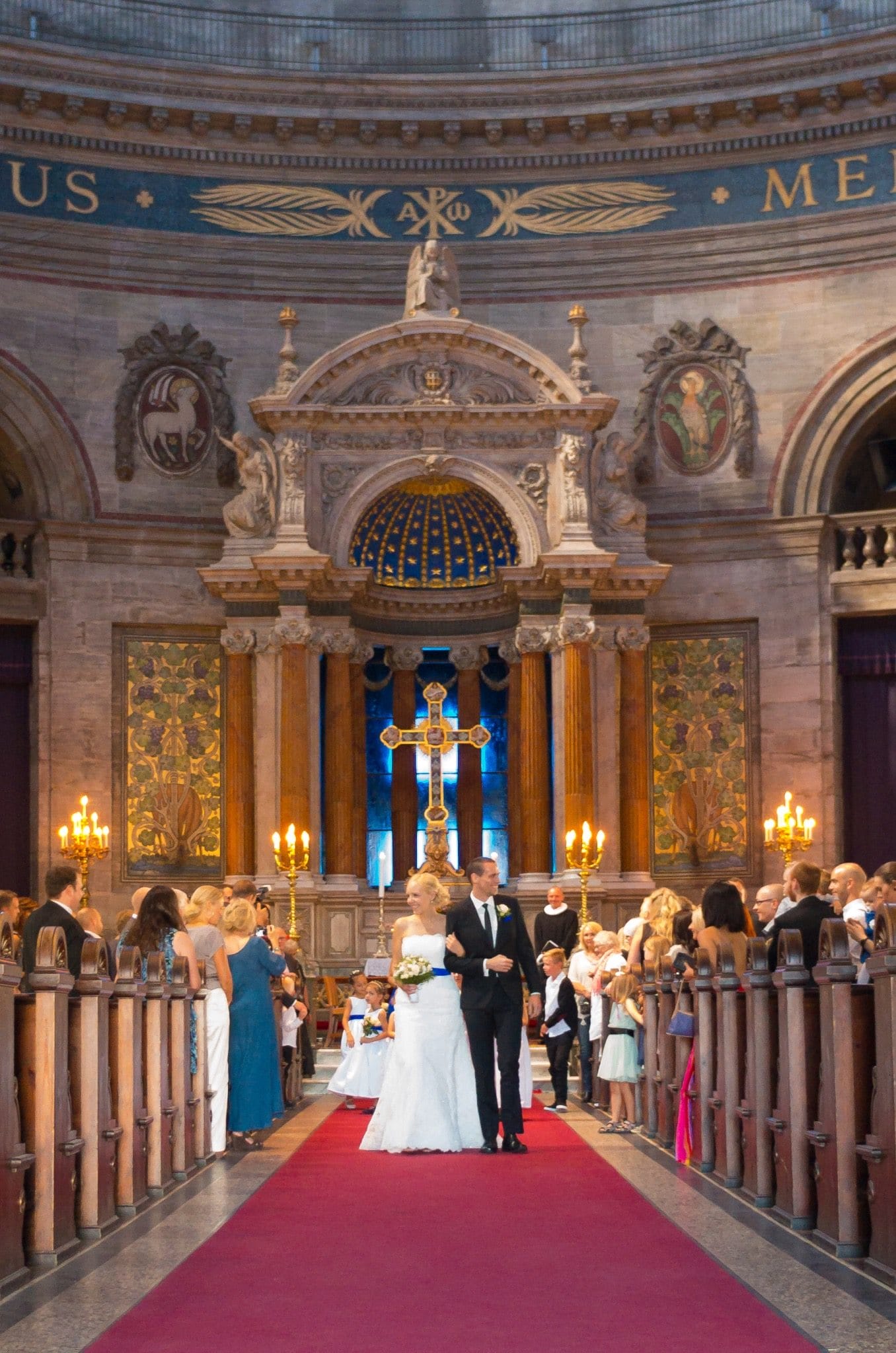 Bride and groom walking down the church aisle