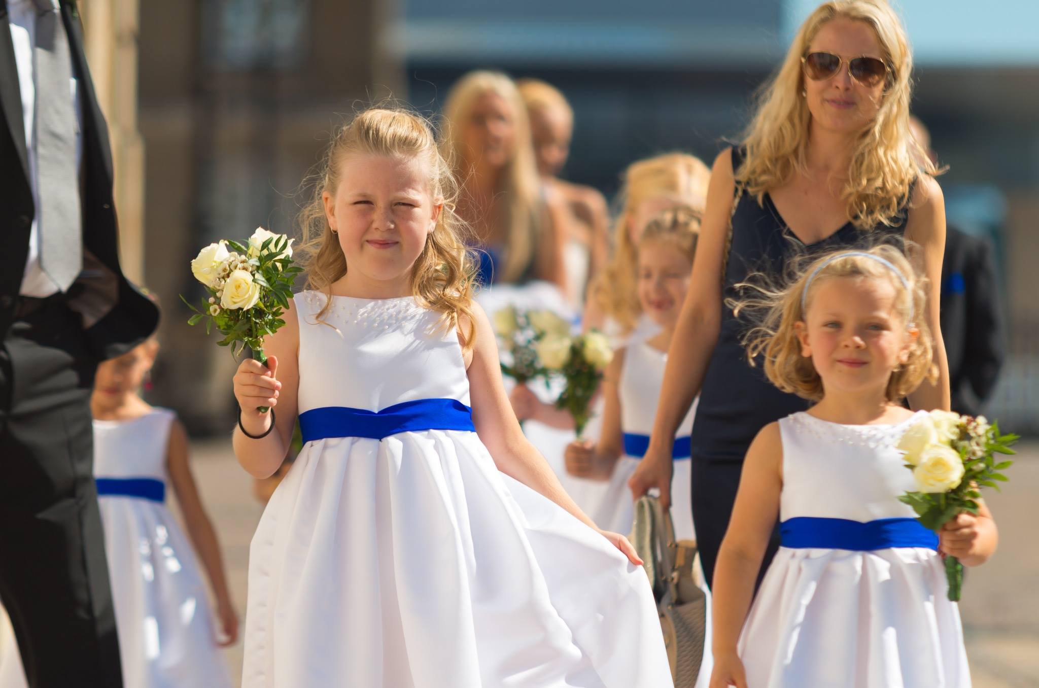 Flower girls carrying bouquets in matching dresses